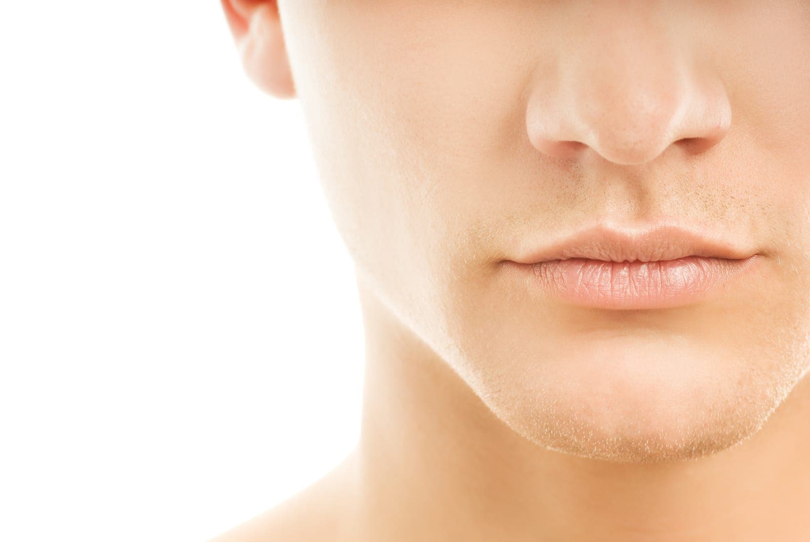 Close-up of a man’s lower face and smooth skin